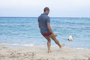 Image showing Man on the beach playing soccer 