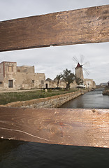 Image showing old mill seen from behind the fence