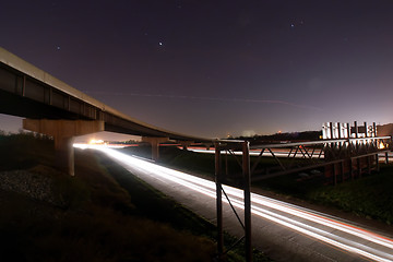 Image showing traffic light trails under bridge