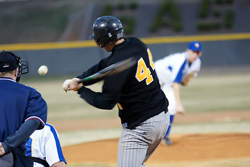 Image showing A batter about to hit a pitch during a baseball game.