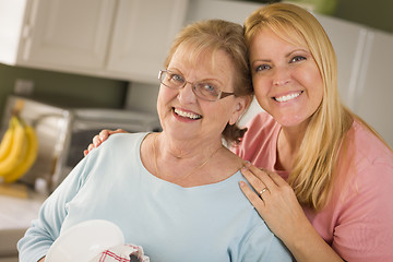 Image showing Senior Adult Woman and Young Daughter Portrait in Kitchen