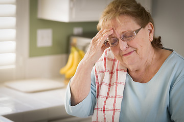 Image showing Sad Crying Senior Adult Woman At Kitchen Sink