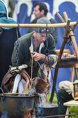 Image showing Medieval Man Preparing Food