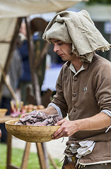 Image showing Medieval Man Preparing Food