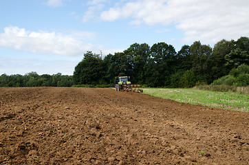 Image showing tractor plowing agricultural field summer 