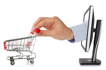 Image showing Computer monitor and hand with shopping cart
