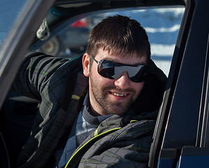 Image showing A young man wearing sunglasses in a private car