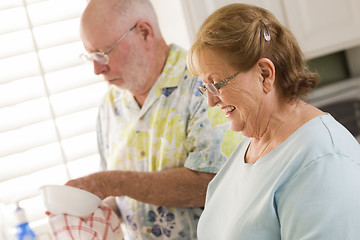 Image showing Senior Adult Couple Washing Dishes Together Inside Kitchen