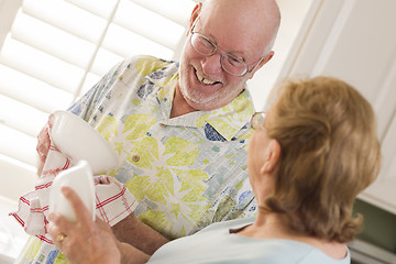 Image showing Senior Adult Couple Washing Dishes Together Inside Kitchen