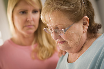 Image showing Young Woman Consoles Senior Adult Female