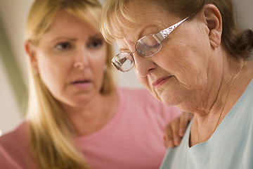 Image showing Young Woman Consoles Senior Adult Female