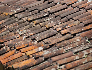 Image showing Old red weathered clay tiled roof surface
