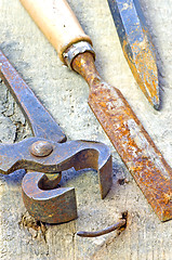 Image showing old rusty pliers with nail