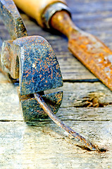 Image showing old rusty pliers with nail