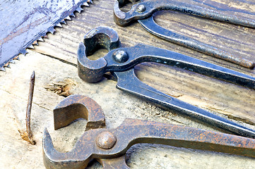 Image showing old rusty pliers with nail