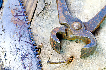 Image showing old rusty pliers with nail