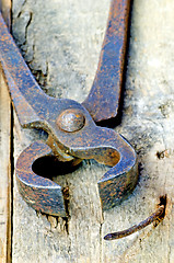 Image showing old rusty pliers with nail