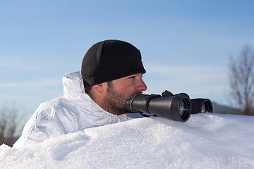 Image showing Scout in white camouflage coat with binoculars