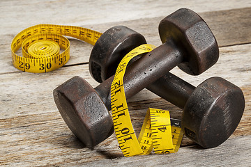 Image showing iron dumbbells and measuring tape