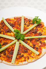 Image showing Turkish beef pizza with cucumber on top