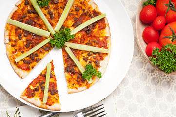 Image showing Turkish beef pizza with cucumber on top