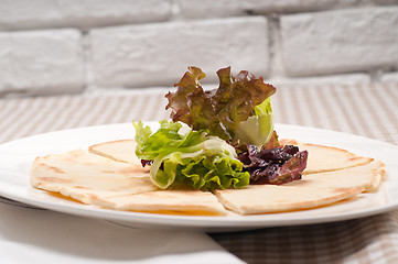 Image showing garlic pita bread pizza with salad on top