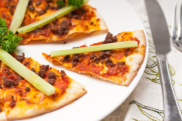 Image showing Turkish beef pizza with cucumber on top