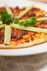 Image showing Turkish beef pizza with cucumber on top