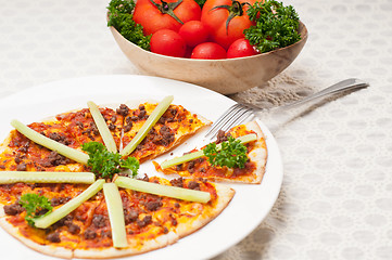 Image showing Turkish beef pizza with cucumber on top