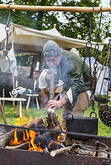 Image showing Medieval man Making the Fire