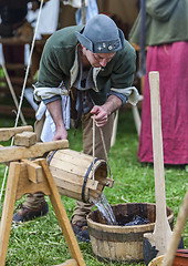 Image showing Medieval Man Pouring Water