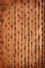 Image showing Vintage wooden background with metal rivets