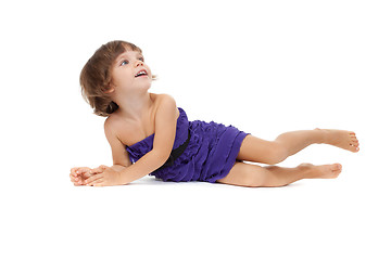 Image showing Happy girl lying on floor, isolated on white