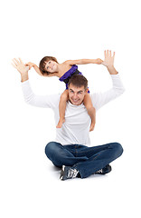 Image showing Cheerful daughter on the neck with his father in the studio