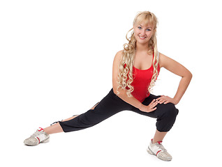 Image showing Beautiful young blonde is engaged in fitness, demonstrates the f