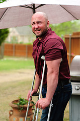 Image showing Man on crutches looking at camera