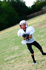 Image showing Young football player catching ball