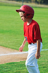 Image showing Baseball player walking across field.