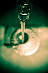 Image showing Water dripping from water tap , artistic retro style toned photo