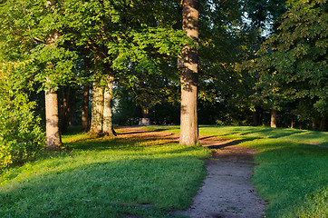 Image showing park path trees morning sun old pagan stone altar 