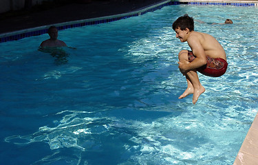 Image showing Boy jumping in the pool