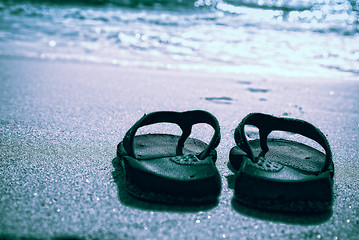 Image showing Flip flops on a sand beach