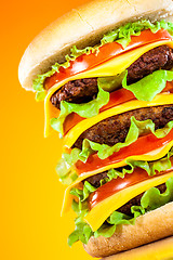 Image showing Tasty and appetizing hamburger on a yellow