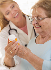 Image showing Female Doctor or Nurse Explaining Prescription to Senior Adult W