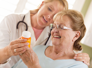 Image showing Female Doctor or Nurse Explaining Prescription to Senior Adult W