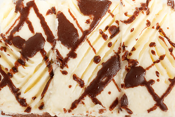 Image showing detail of white icing and chocolate on cake 