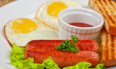 Image showing Fried eggs with sausages