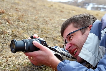 Image showing man taking pictures in the field