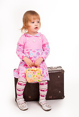 Image showing portrait of adorable young girl on old suitcase