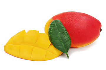 Image showing Fresh mango fruit with cut and green leaves isolated on white ba